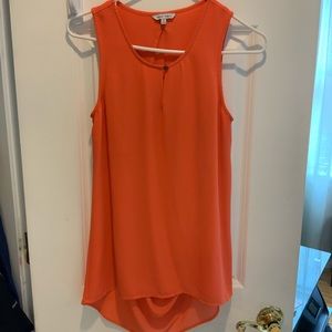 Salmon colored sleeveless blouse with slitted back